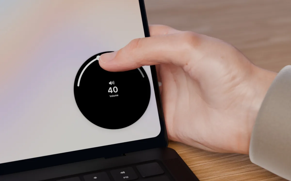 The thumb slides around the dial's rim, turning the volume to 40.